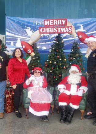 Supervisor Karen Spiegel and grandson with Santa and Mrs. Clause and a Corona Police Officer
